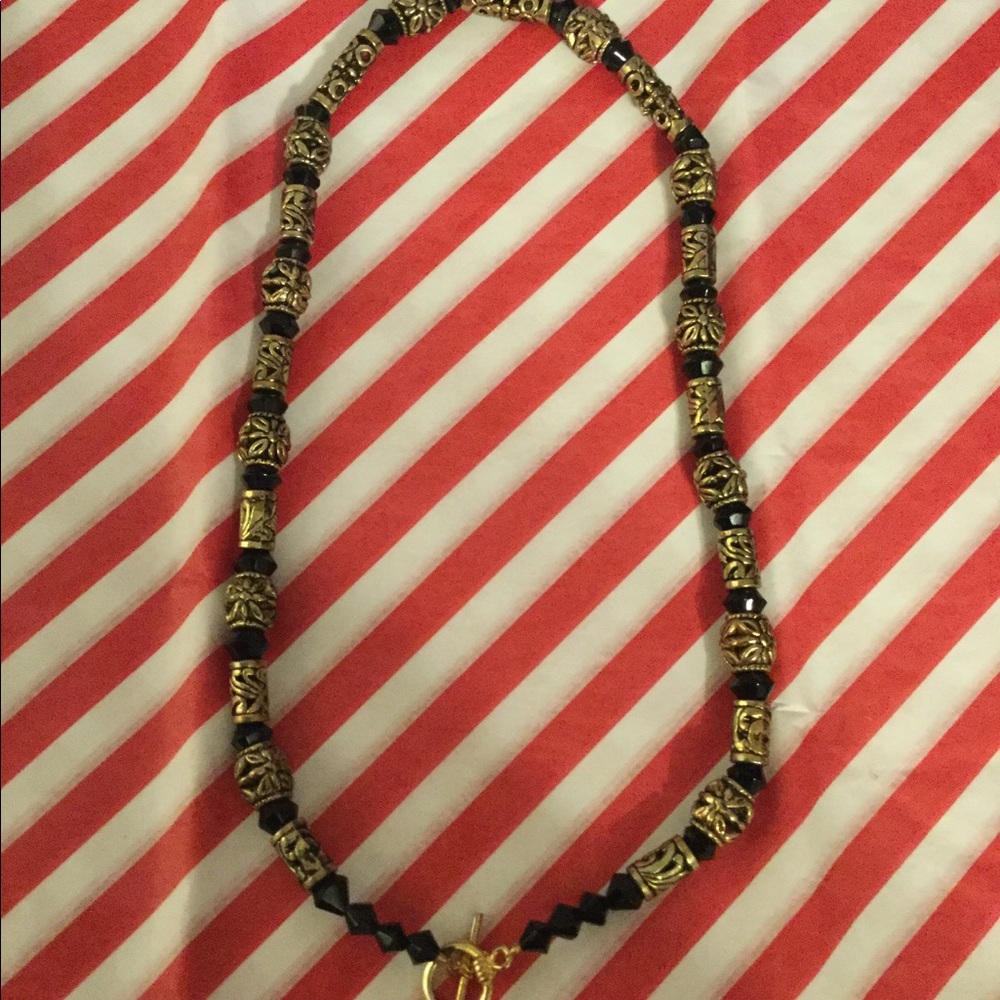 black necklace with gold colored details